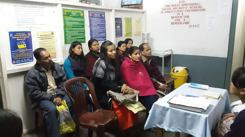 Beneficiaries and insured persons seated at the clinic waiting room during ESIC Day
