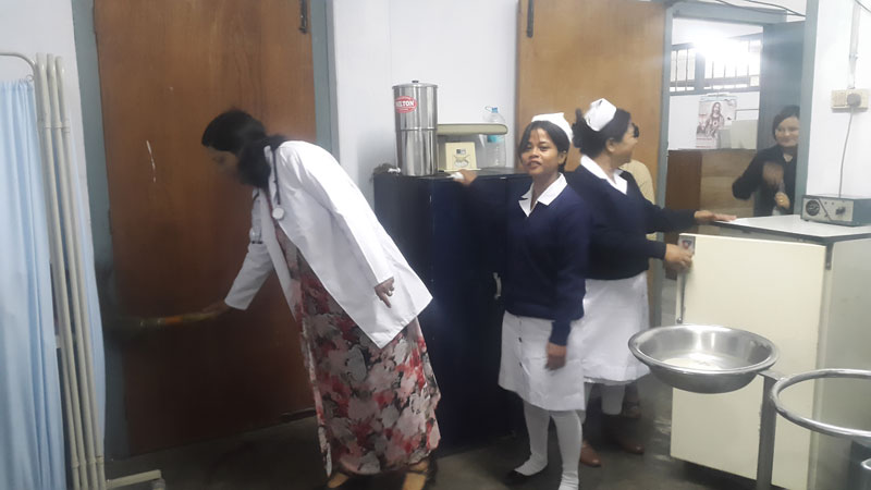 Staff members cleaning the dispensary rooms as part of the celebration cleaning initiative